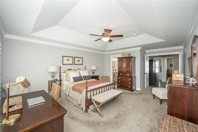 bedroom with ceiling fan, a tray ceiling, crown molding, and carpet flooring