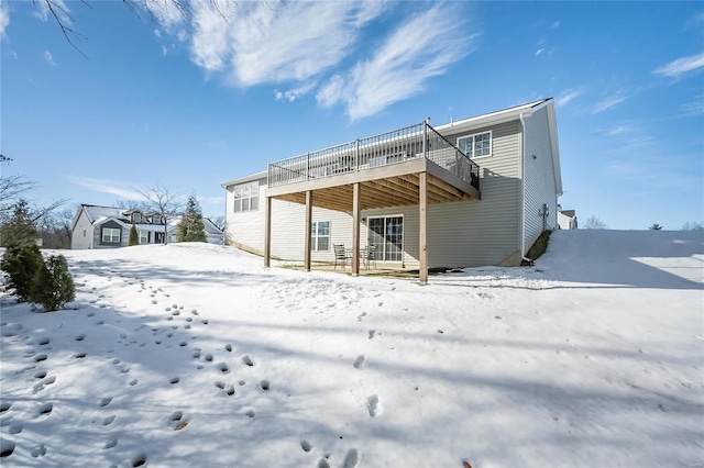 snow covered property featuring a deck