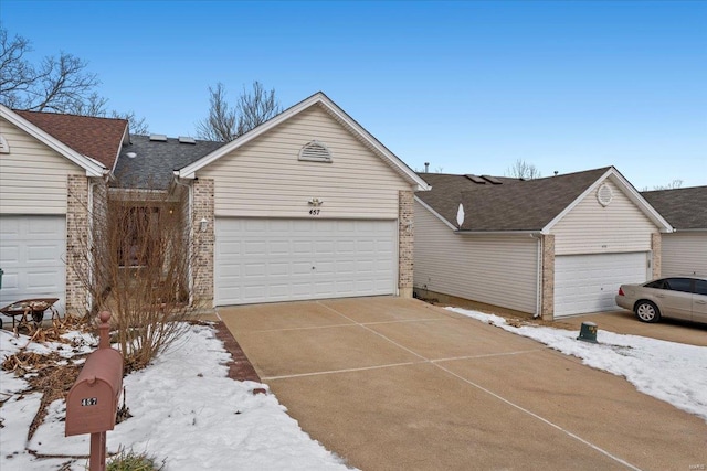 view of front facade with brick siding and an attached garage