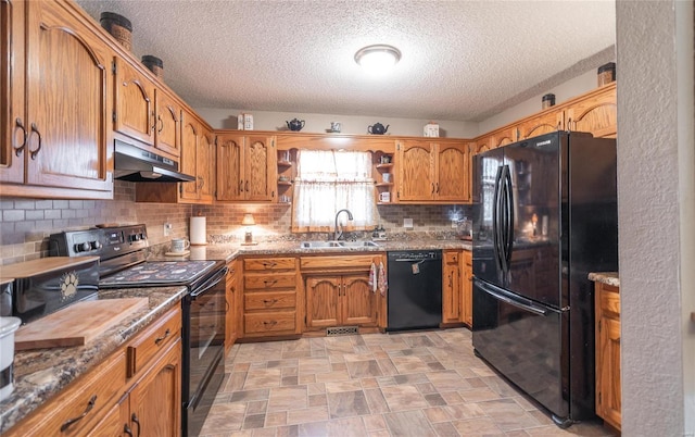 kitchen with sink, light stone counters, a textured ceiling, decorative backsplash, and black appliances