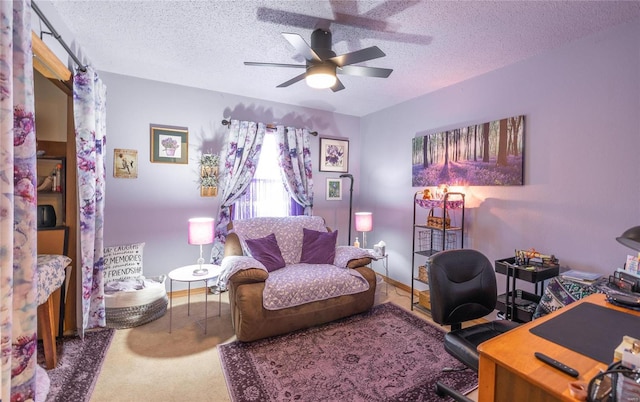 carpeted office with ceiling fan and a textured ceiling