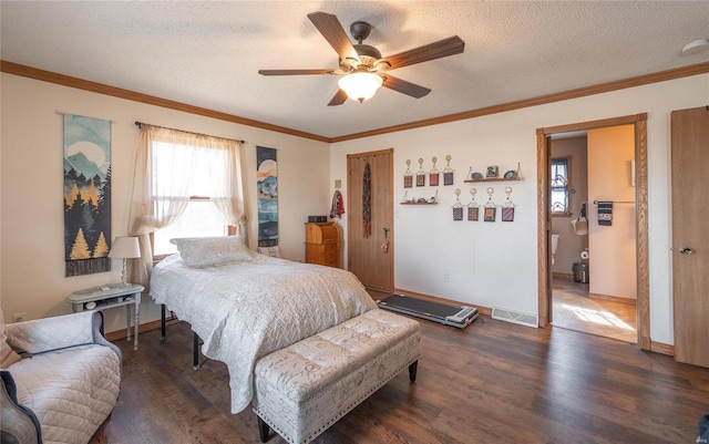 bedroom with crown molding, dark hardwood / wood-style floors, ceiling fan, and a textured ceiling