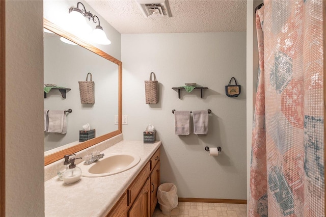 bathroom featuring vanity and a textured ceiling