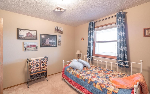 carpeted bedroom featuring a textured ceiling