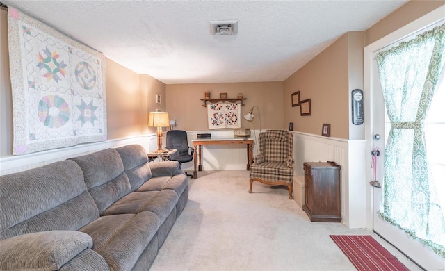 living room with a textured ceiling and carpet flooring