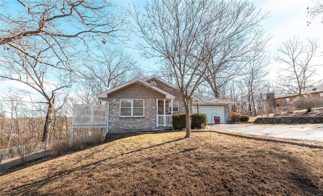 ranch-style house with a garage and a front lawn