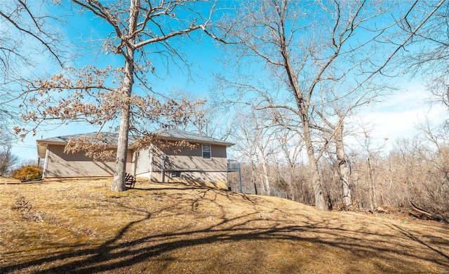 view of home's exterior with a lawn