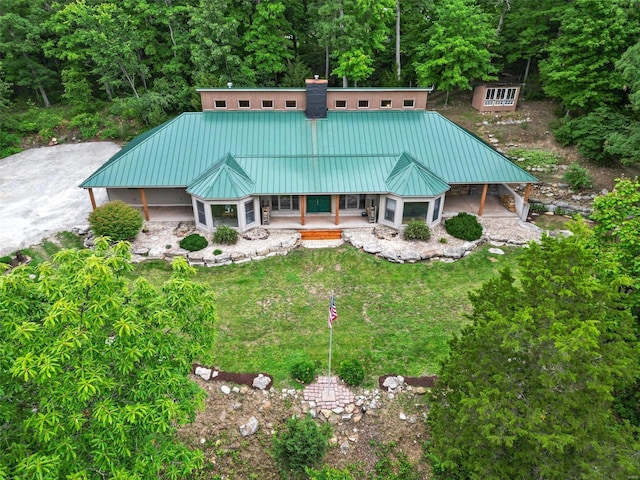 back of house with a porch and a yard