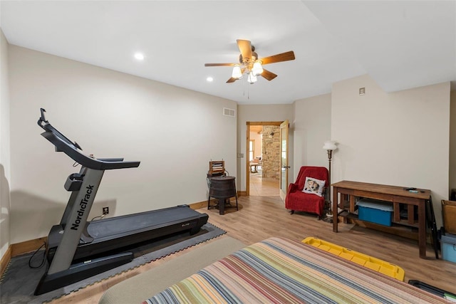 workout room featuring light hardwood / wood-style floors and ceiling fan