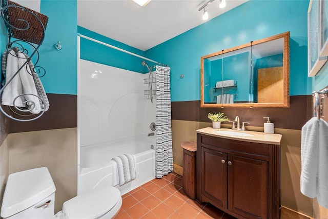 full bathroom with vanity, track lighting, shower / bath combination with curtain, tile patterned floors, and toilet