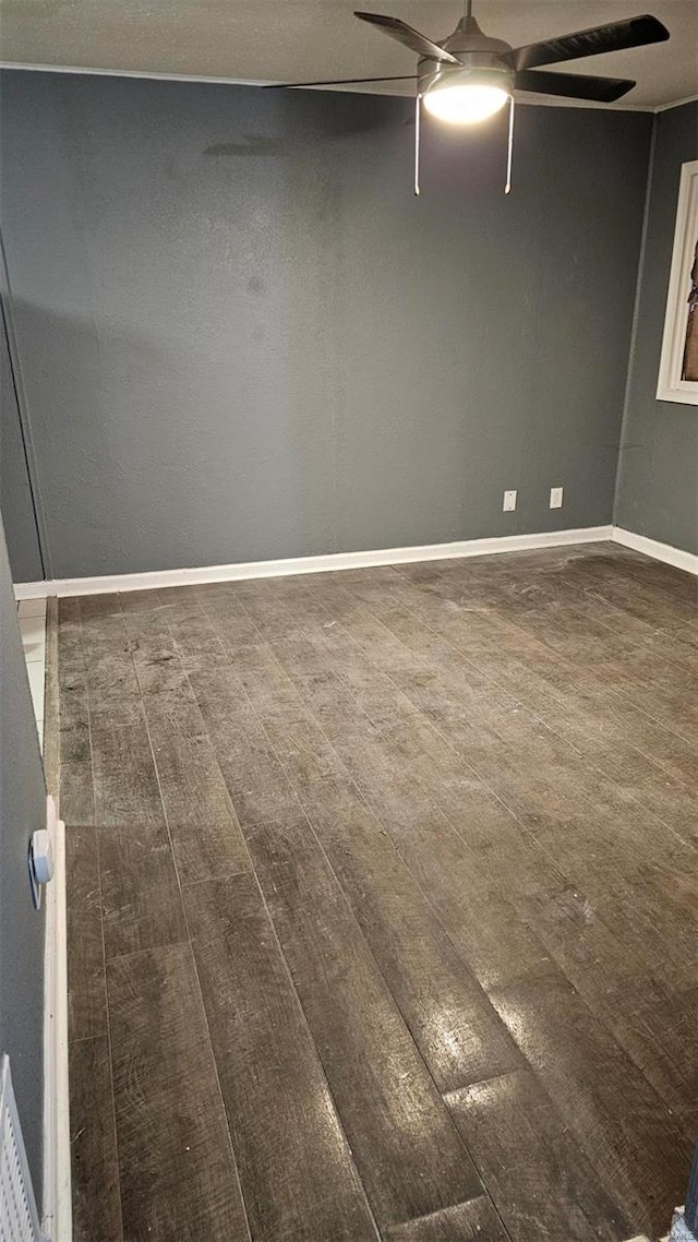 spare room featuring dark hardwood / wood-style floors and ceiling fan