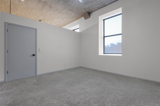 additional living space with carpet and beam ceiling