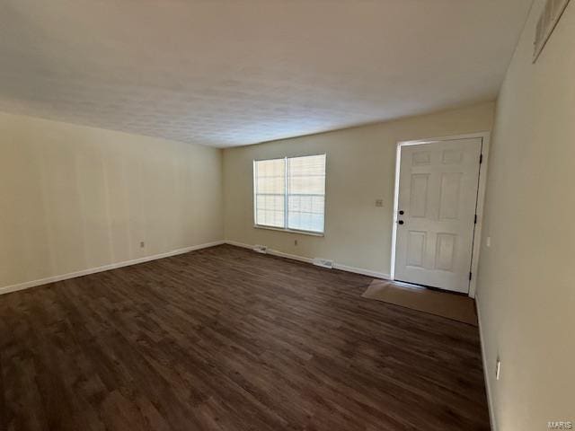 empty room featuring dark wood-type flooring