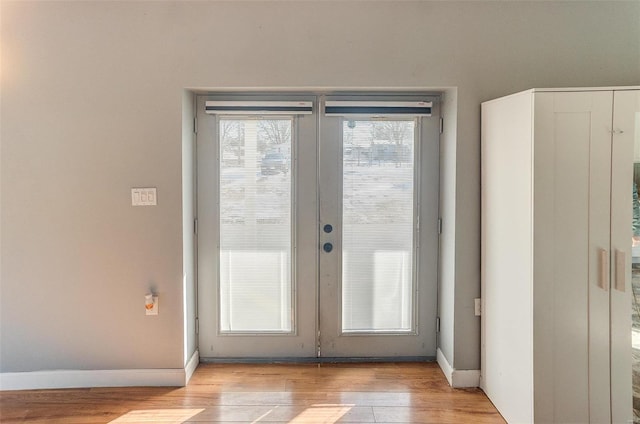 doorway to outside with french doors and light hardwood / wood-style floors