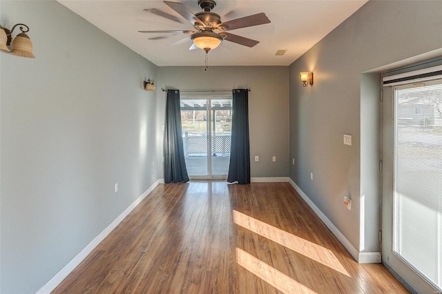 empty room with ceiling fan and light wood-type flooring