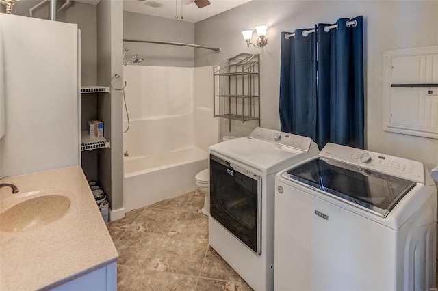 washroom with sink, electric panel, washing machine and clothes dryer, and ceiling fan