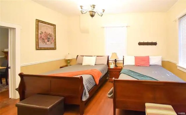 bedroom featuring multiple windows and wood finished floors