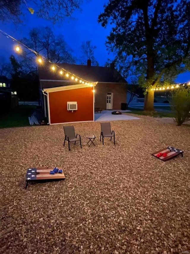 exterior space with a patio area and a wall mounted air conditioner