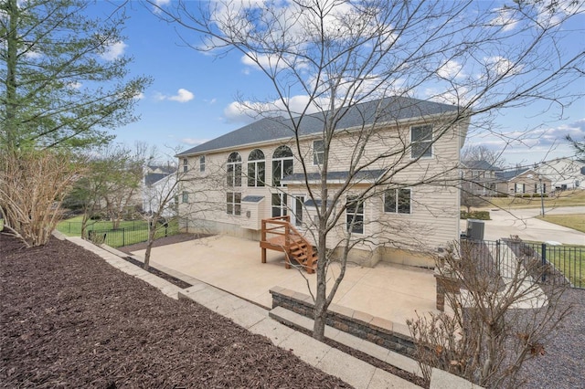 back of property featuring a patio and fence