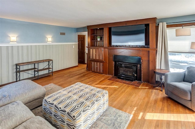 living room featuring hardwood / wood-style floors and wood walls