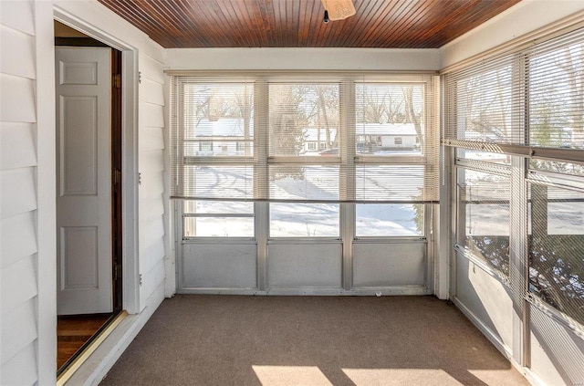 unfurnished sunroom with a wealth of natural light and wood ceiling