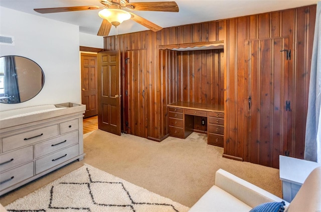 carpeted bedroom with wooden walls