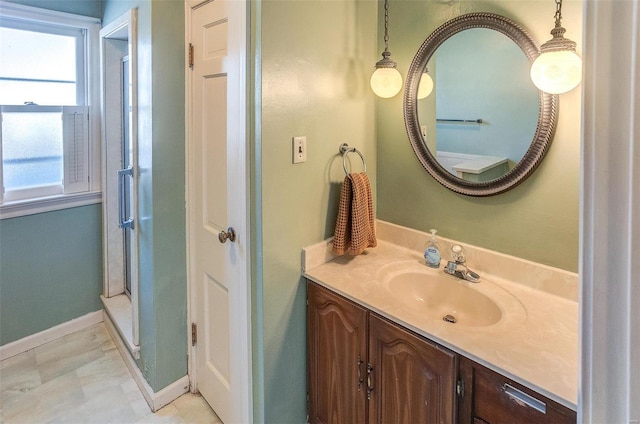 bathroom with walk in shower and vanity