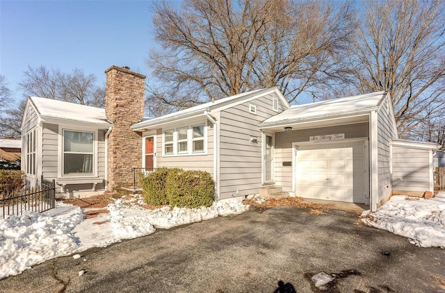 view of snow covered exterior with a garage