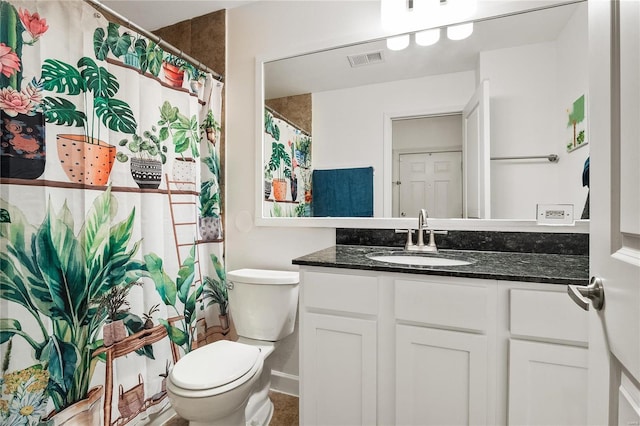 bathroom featuring toilet and vanity