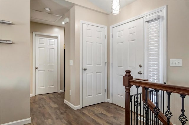 foyer entrance featuring dark wood-style floors and baseboards