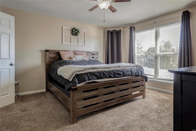 bedroom featuring a ceiling fan, light carpet, and baseboards