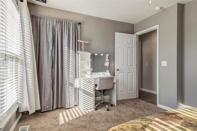 bedroom with carpet, visible vents, and baseboards