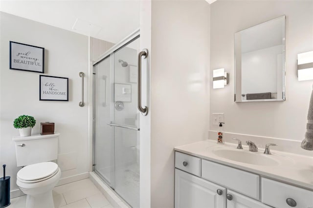 bathroom with vanity, toilet, a shower with door, and tile patterned flooring