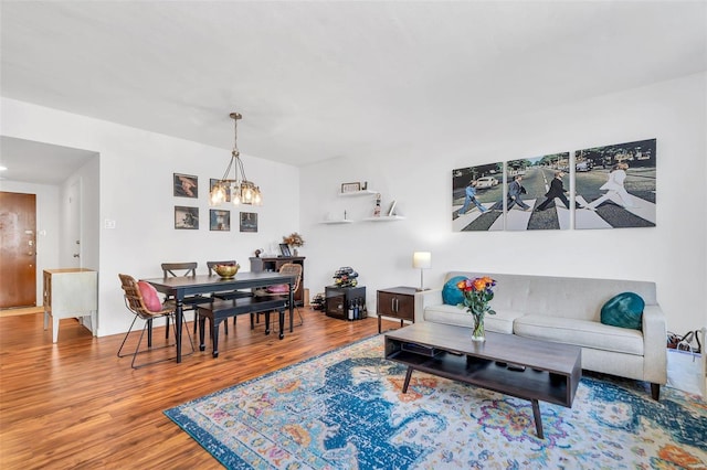 living area with an inviting chandelier and wood finished floors