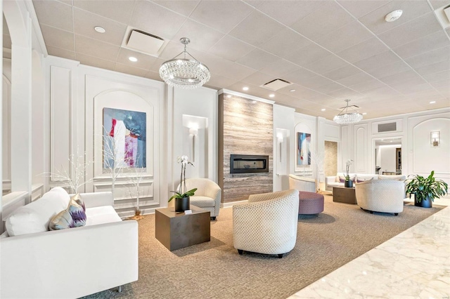 living room featuring a decorative wall, recessed lighting, a fireplace, and visible vents