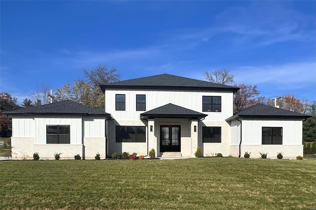 view of front of property featuring french doors and a front lawn