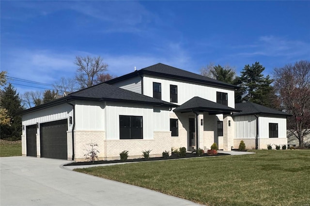 view of front of property with a garage and a front lawn