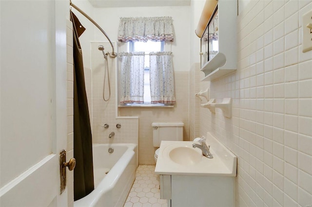 full bathroom with toilet, vanity, tile patterned flooring, tile walls, and shower / bathtub combination with curtain