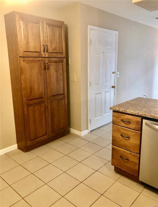 kitchen featuring light tile patterned flooring and dishwasher