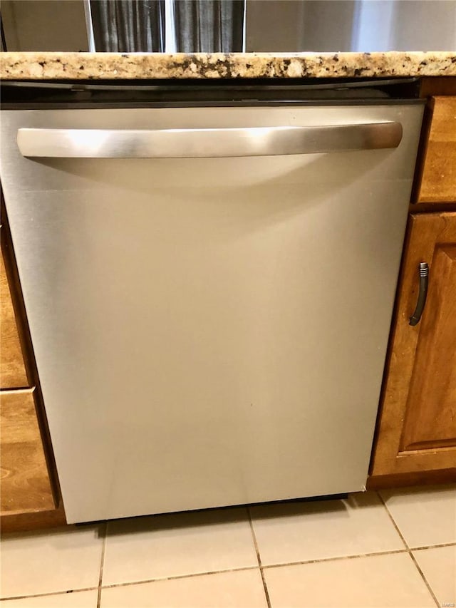 details featuring dishwasher and light stone counters