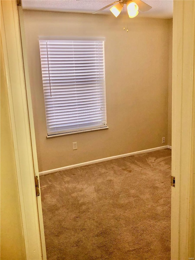 carpeted empty room with ceiling fan