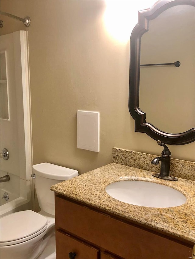 full bathroom featuring toilet, vanity, and tub / shower combination