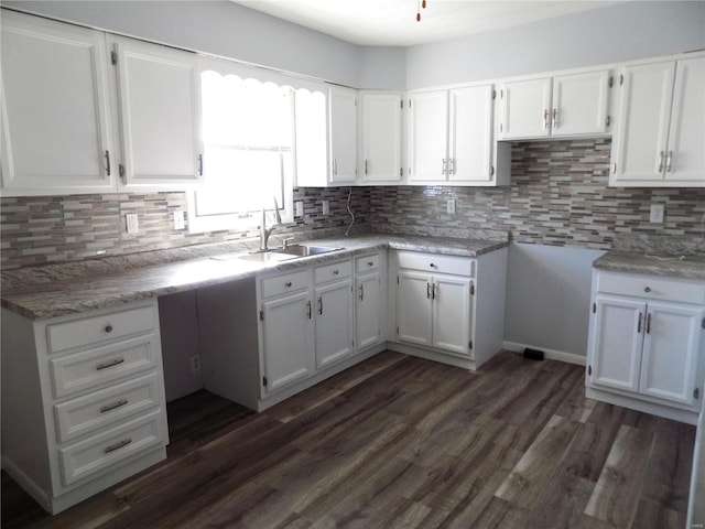 kitchen featuring sink, dark hardwood / wood-style flooring, and white cabinets