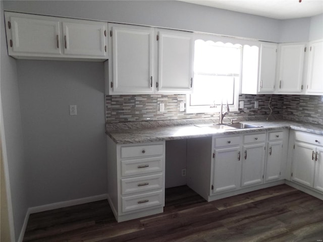 kitchen with sink, white cabinets, dark hardwood / wood-style flooring, and decorative backsplash