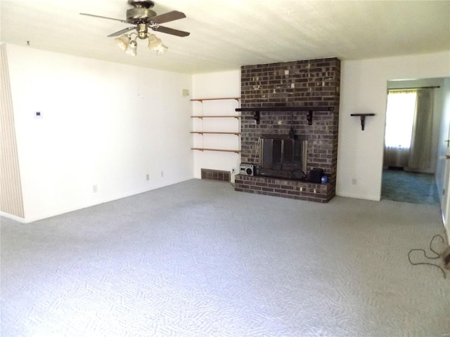 unfurnished living room featuring a fireplace, ceiling fan, and carpet floors