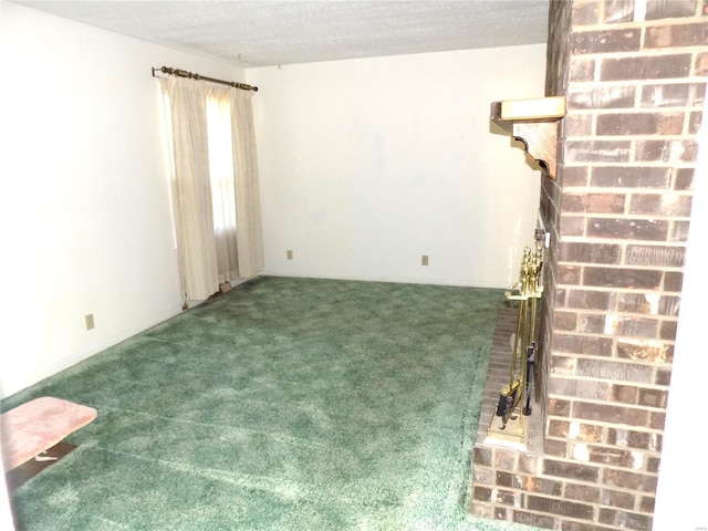 empty room with a brick fireplace and dark carpet