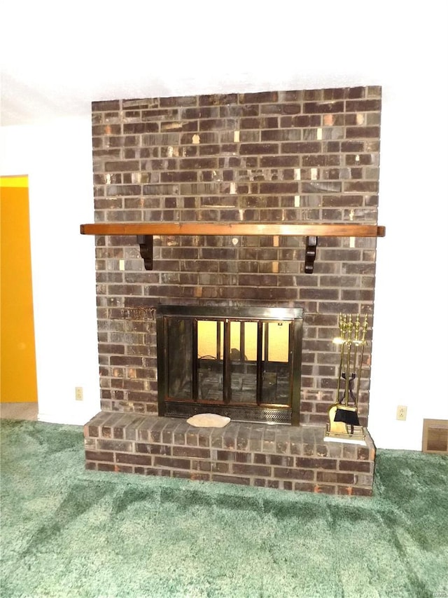 interior details with a fireplace and carpet floors