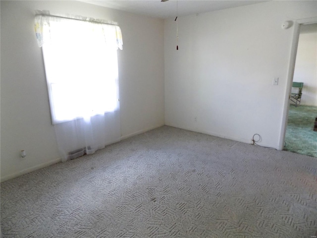 empty room featuring light colored carpet and plenty of natural light