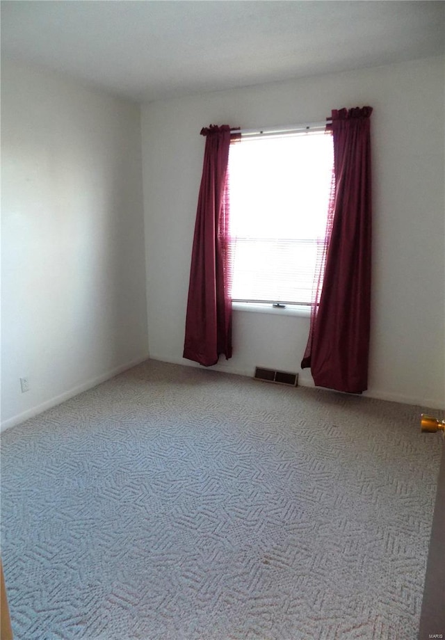 spare room with carpet floors and plenty of natural light