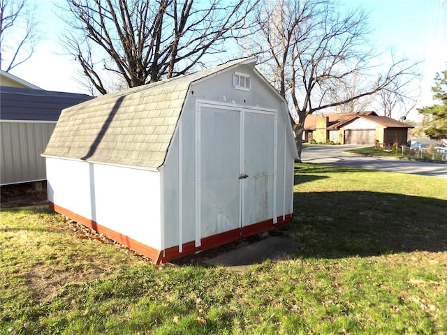 view of outdoor structure with a lawn